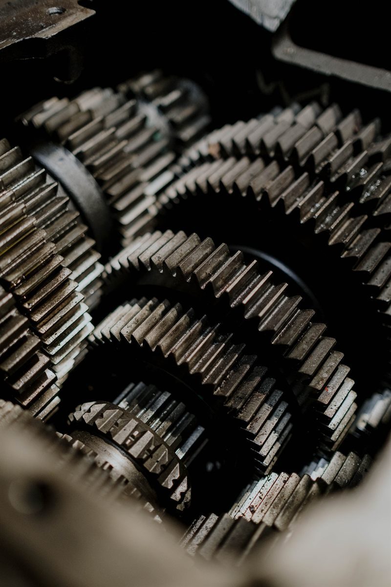 Close-up of gear trains inside industrial rotating machinery